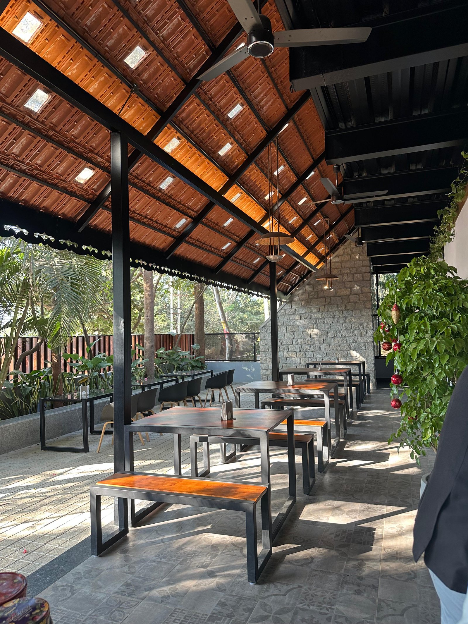 Open verandah seating with a tall thatched roof